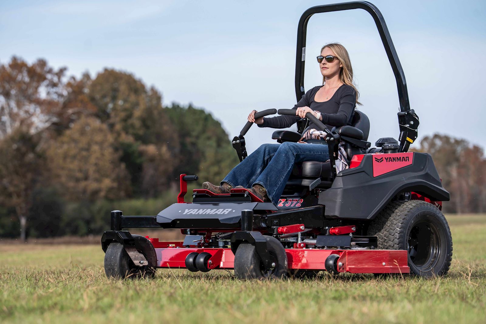 woman mowing an open field